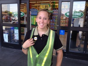 A Food 4 Less worker wears her "Hard Work Fair Pay" button.