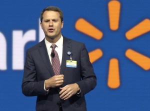 FILE - In this June 5, 2015 file photo, Wal-Mart Store, Inc., Chief Executive Officer Doug McMillon speaks at the Wal-Mart shareholder meeting in Fayetteville, Ark. Wal-Mart on Wednesday, Oct. 14, 2015 said it expects profit to fall for its next fiscal year and cut its sales outlook for this year as it works to fend off intensifying competition and perk up stores with better customer service. (AP Photo/Danny Johnston, File)