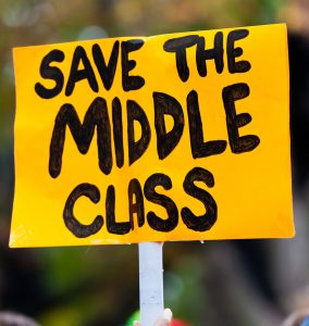 A protest sign reading "Save the Middle Class".